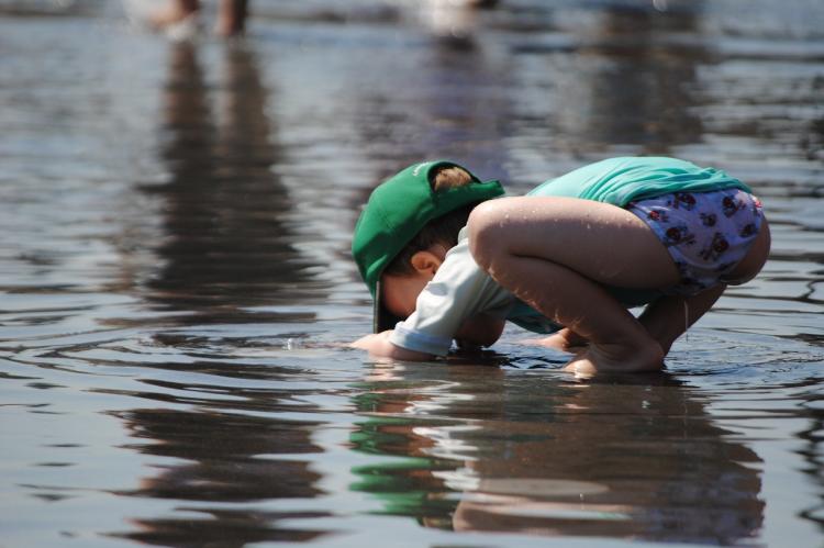 child-playing-in-water-toddler-in-summer-child